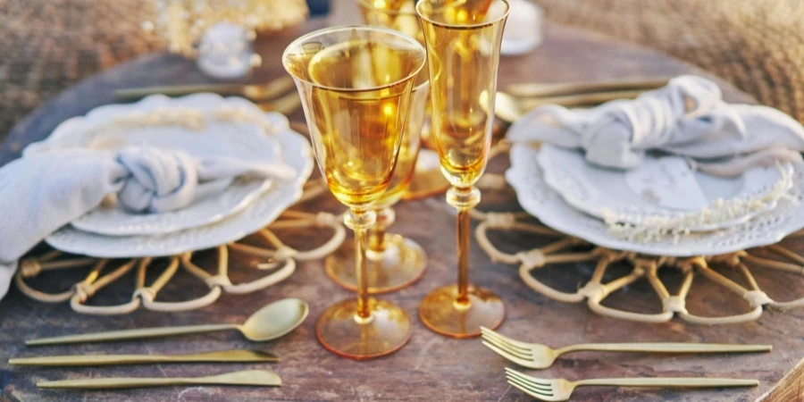 Glasses and Golden Silverware on Table