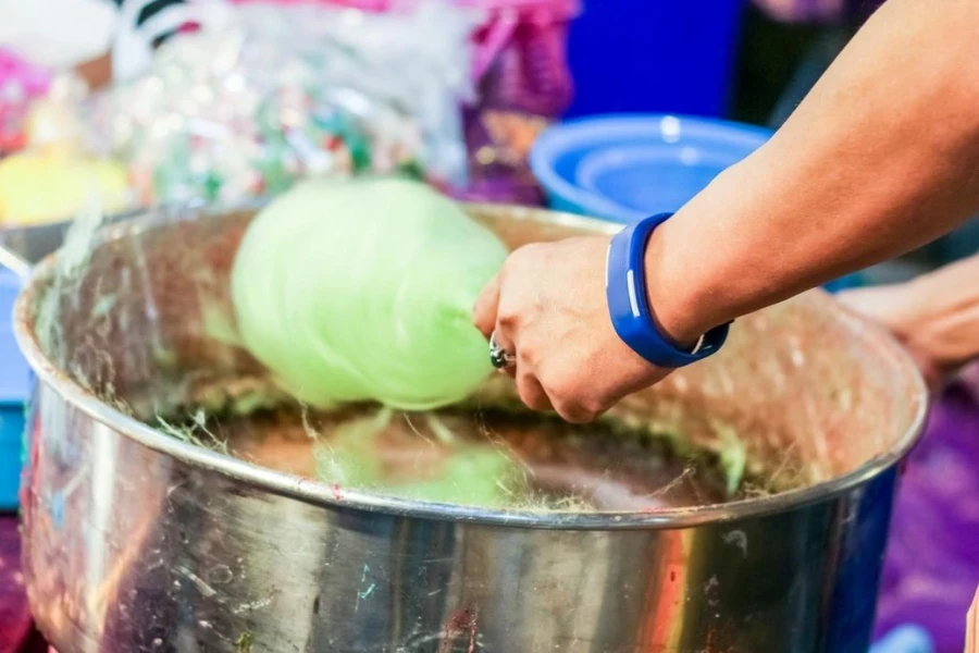 Hand Rolling Cotton Candy in Candy Floss Machine