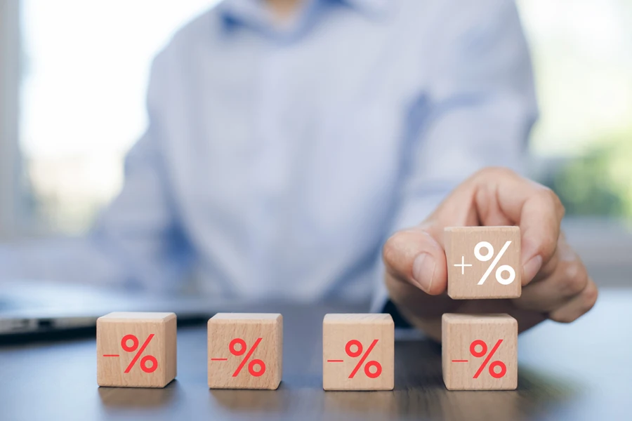 Man using wooden cubes to represent percentage markup