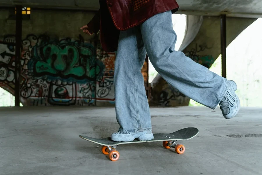 Person in baggy jeans riding a skateboard