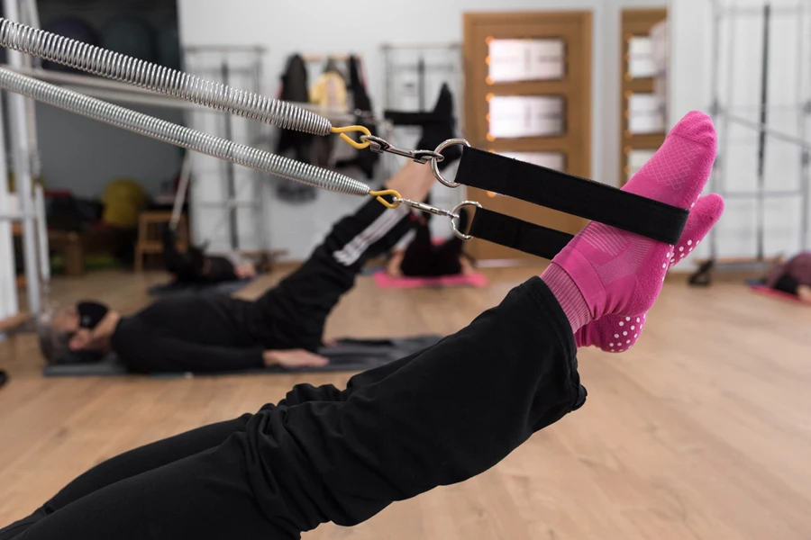 Person in pilates wearing pink socks during dynamic studio sessions