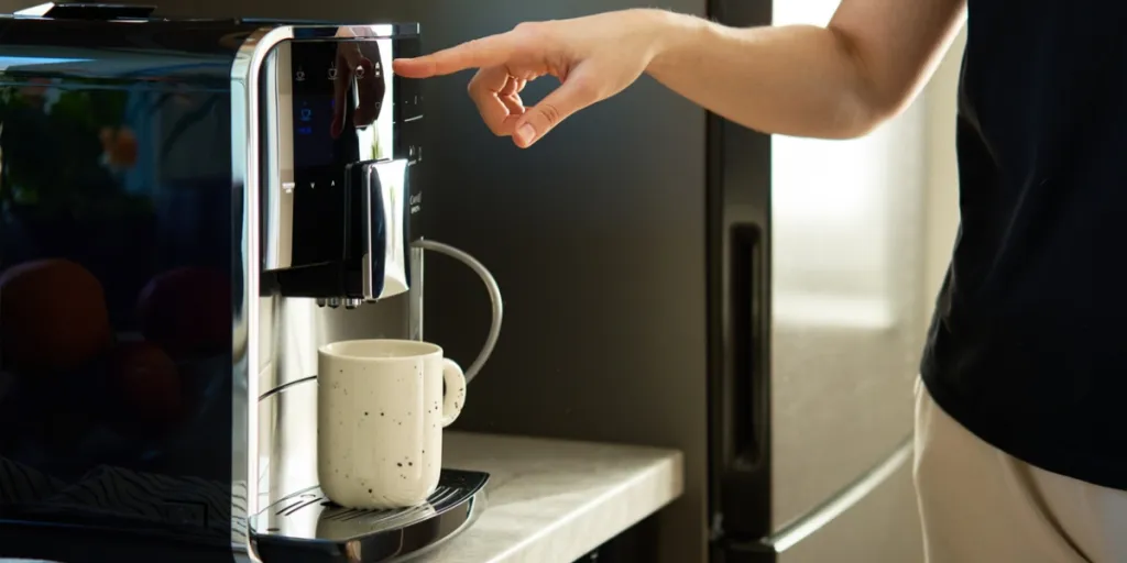 Person preparing coffee with a coffee maker