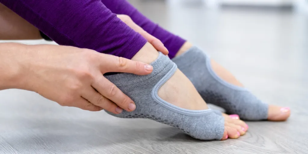 Person wearing gray socks with grips on the bottom