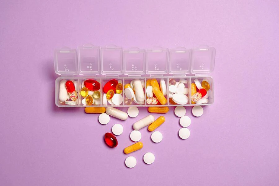 Pills organized in a container with multiple compartments