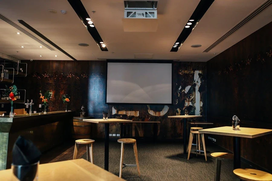 Retractable electric projector screens in a dining setting