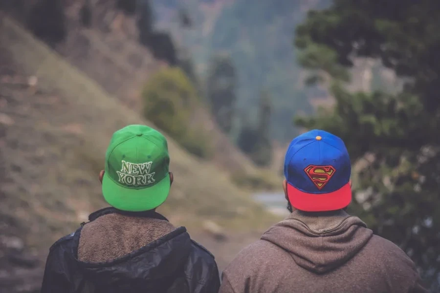 Two men wearing low-profile five-panel hats