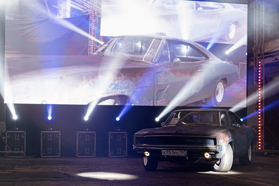 Vintage car in front of a large projector screen