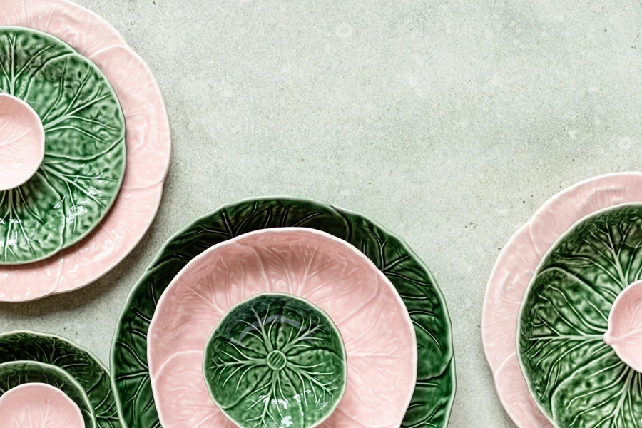 a group of green and pink plates sitting on top of a table