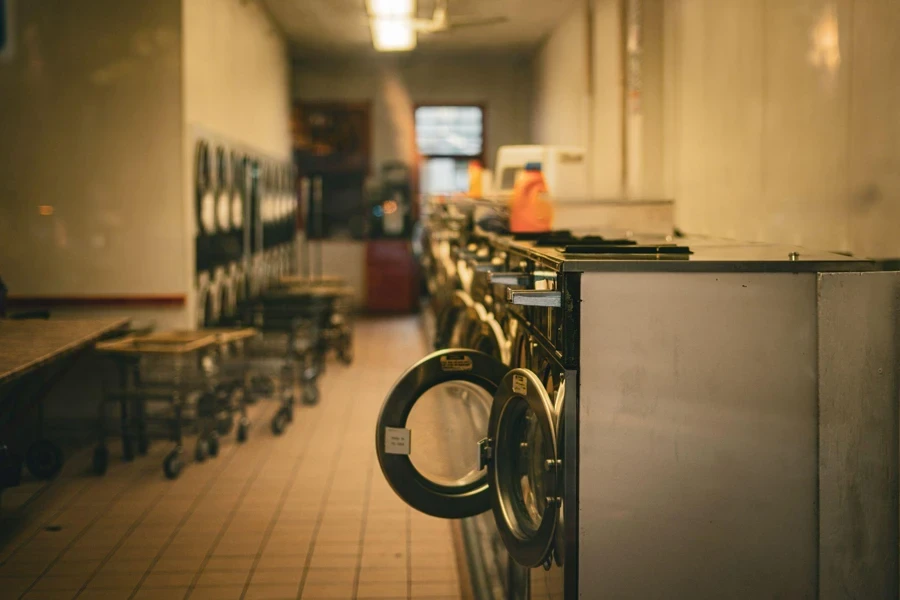 a row of front load washers in a laundry room