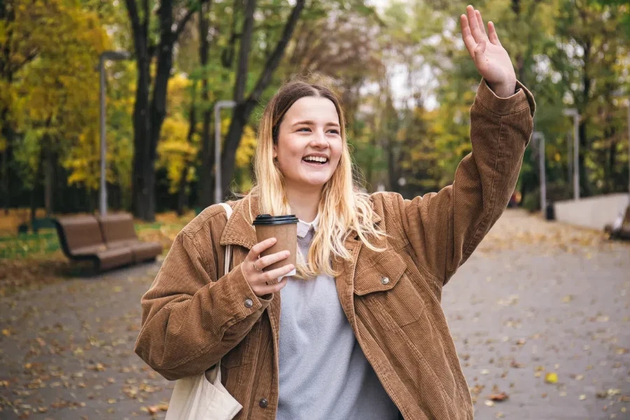 A young woman in an oversized corduroy jacket