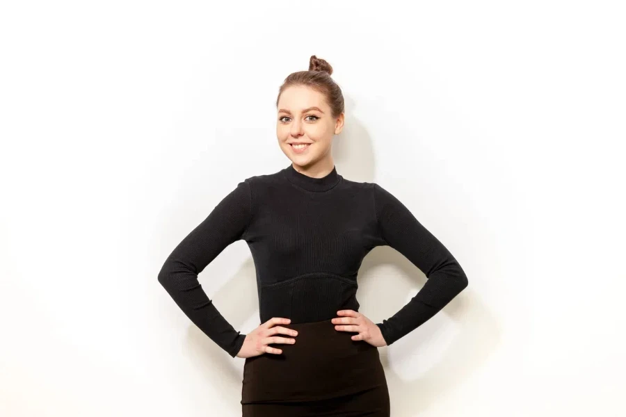 Cheerful young woman in a black bodysuit and brown