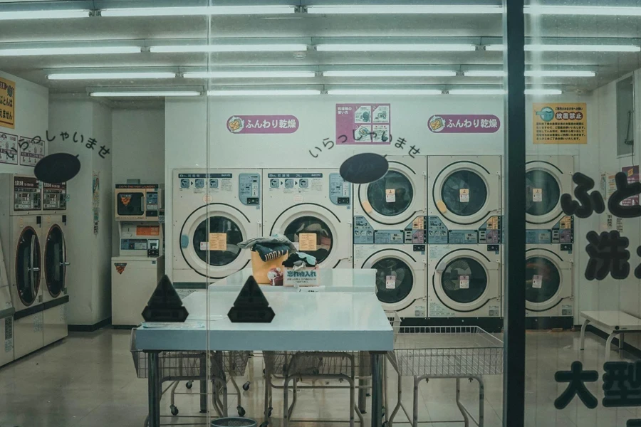 laundromat room with modern commercial washers and dryers