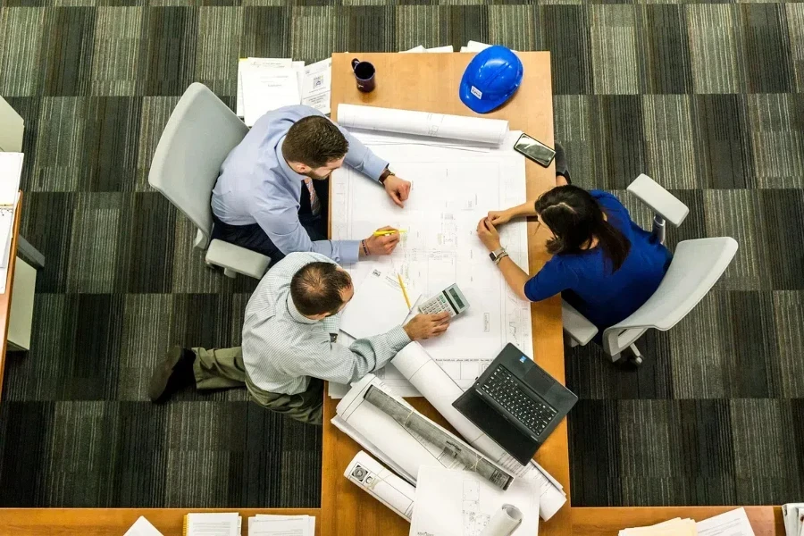 Three people meeting over a conference table