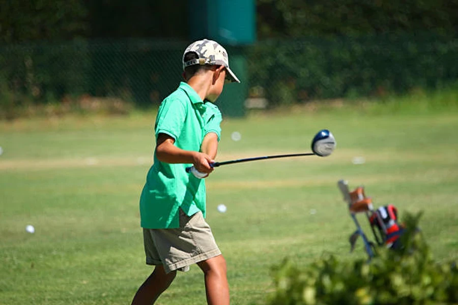 A Young Boy Hitting Golf Balls at a Driving Range