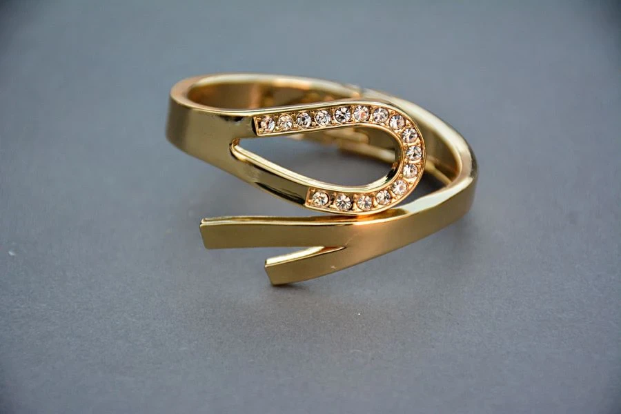 A gold ring with white gemstones