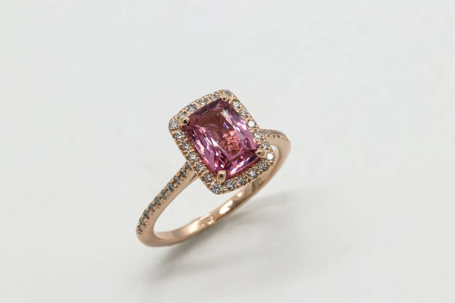 A rose gold cushion cut pink sapphire ring