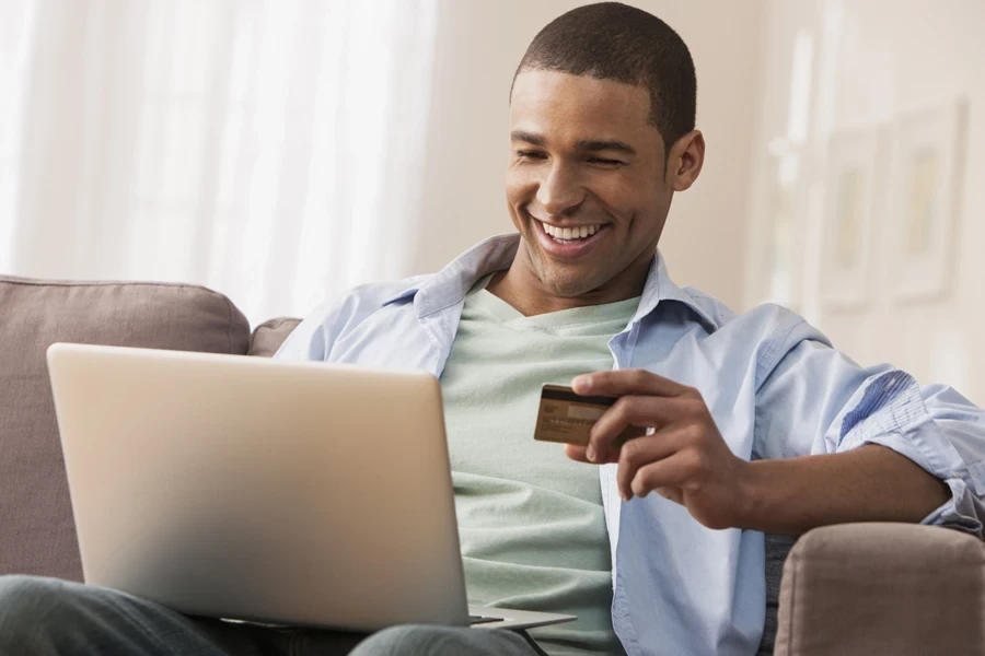 A smiling man pre-ordering something online