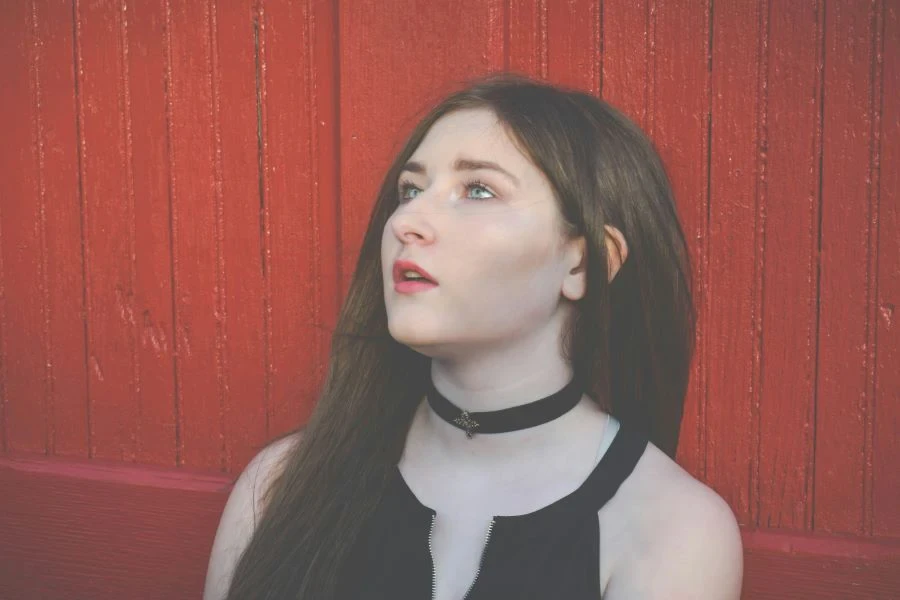 A woman wearing a black choker necklace