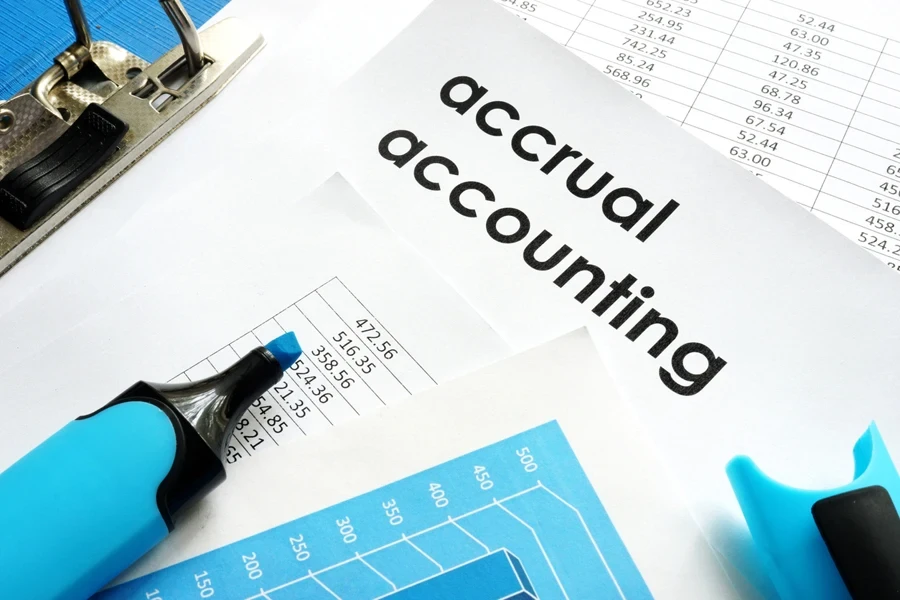 An accrual accounting document and a blue marker