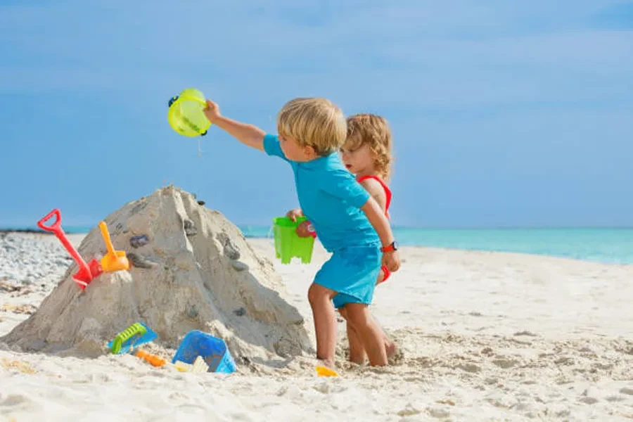 Boy and Sister Girl Play with Sand