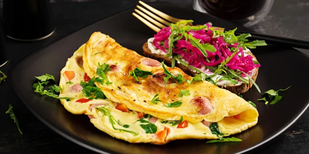 Breakfast. Omelette with sausage, sweet peppers and sandwich with marinated red onions. Frittata - italian omelet.