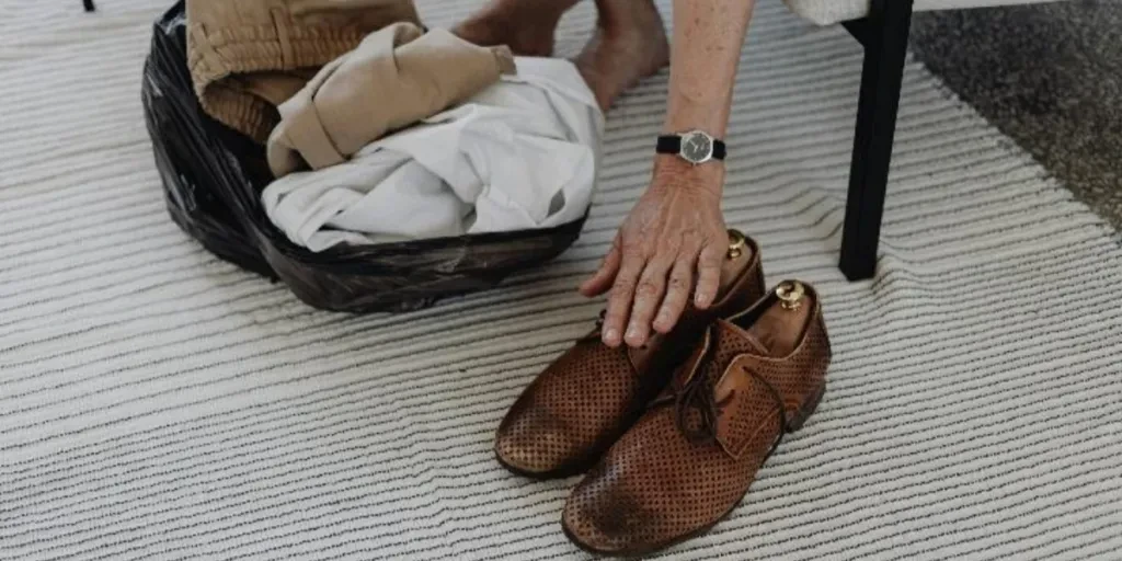 Brown leather shoes on striped area rug