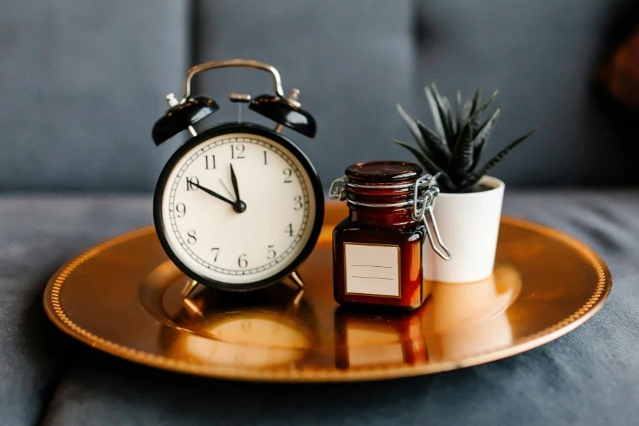 Close-Up of Tray with Clock, Jar, and Potted Plant