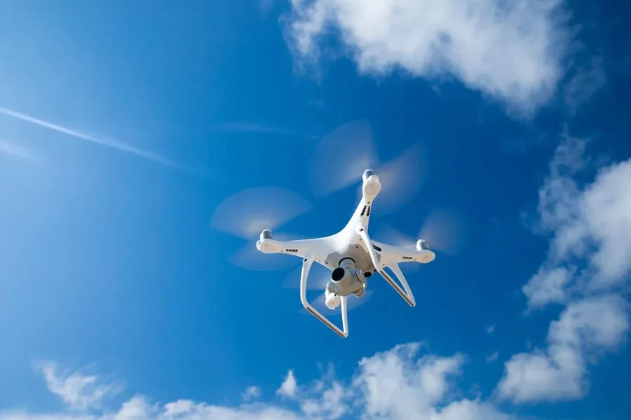 Drone flies in the blue sky