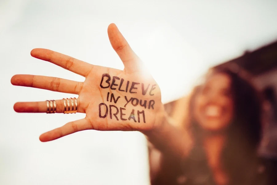 Girl with optimistic writing on her palm