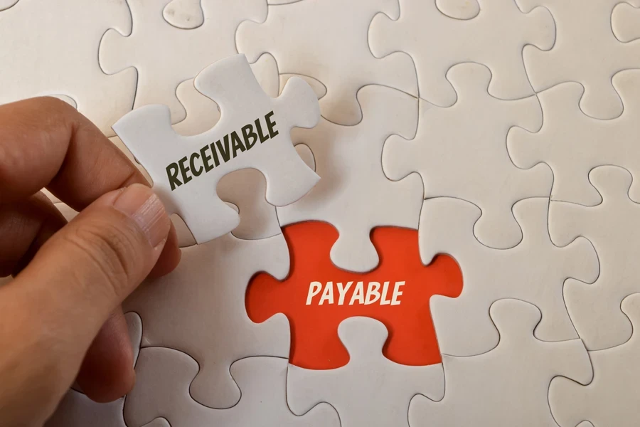 Jigsaw puzzle with words Receivable” and Payable