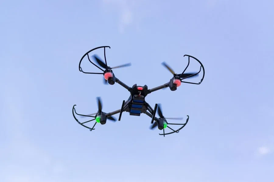 Quad copter flying drone in the blue sky