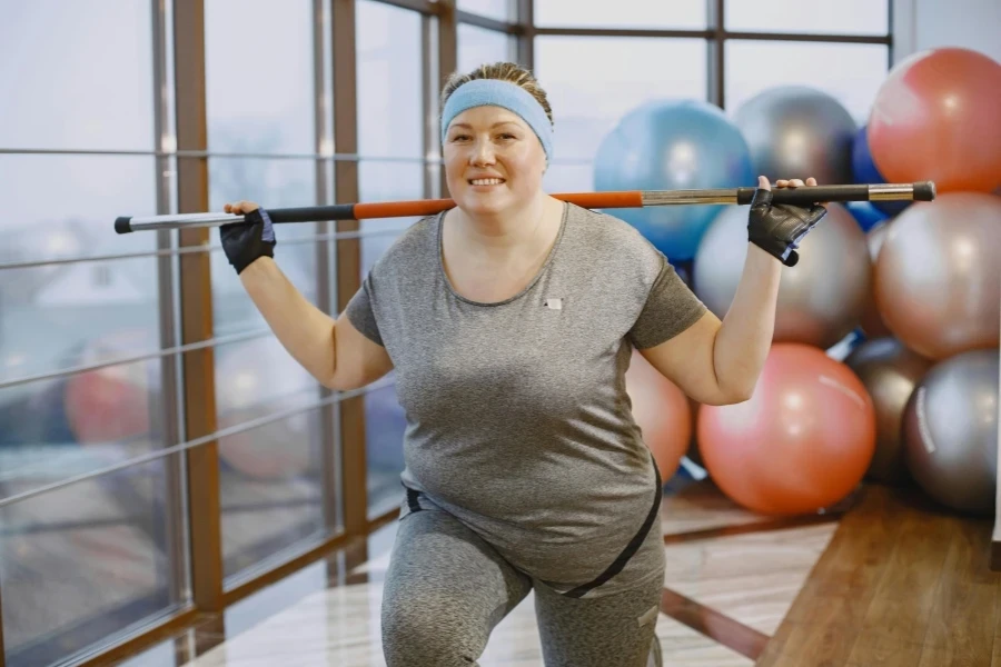 Smiling Plus Size Woman Exercising at Gym