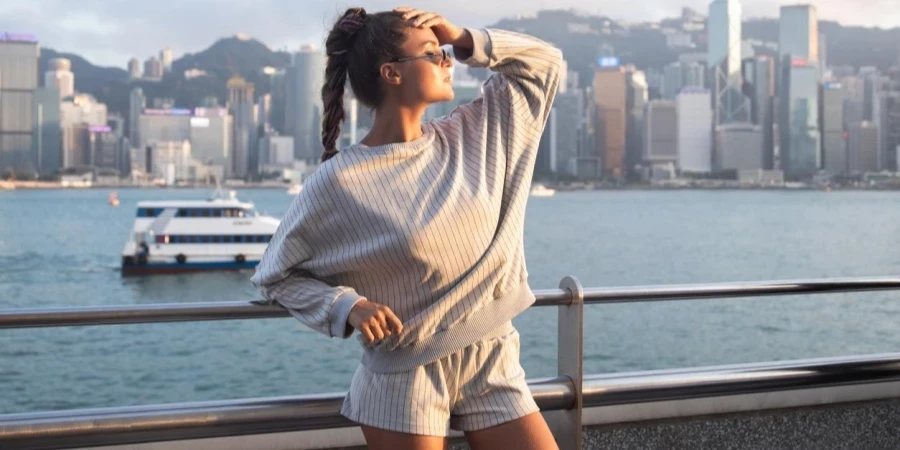 Stylish Woman Is Posing in the Victoria Harbour, Hong Kong City