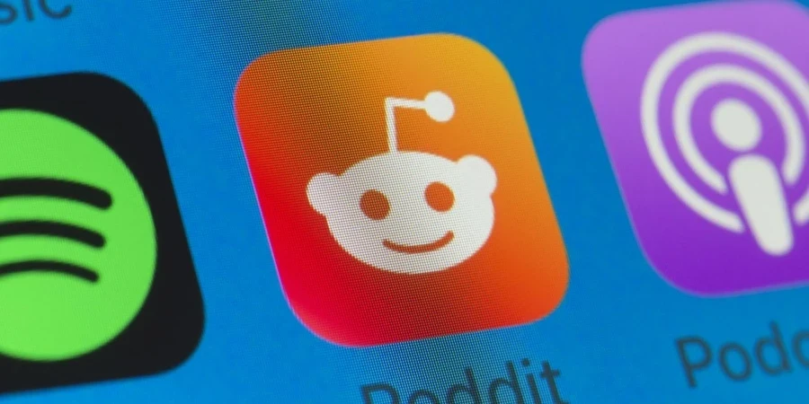 The buttons of Reddit, Spotify, Podcasts, WhatsApp and Music on the screen of an iPhone.