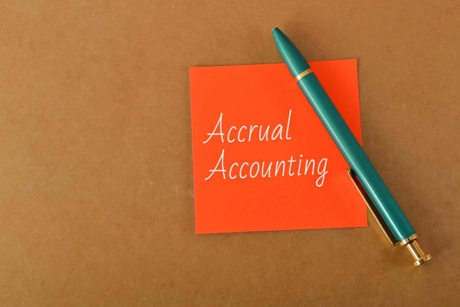 The words “Accrual Accounting” on an orange paper