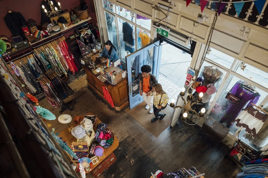 Two people entering a consignment store