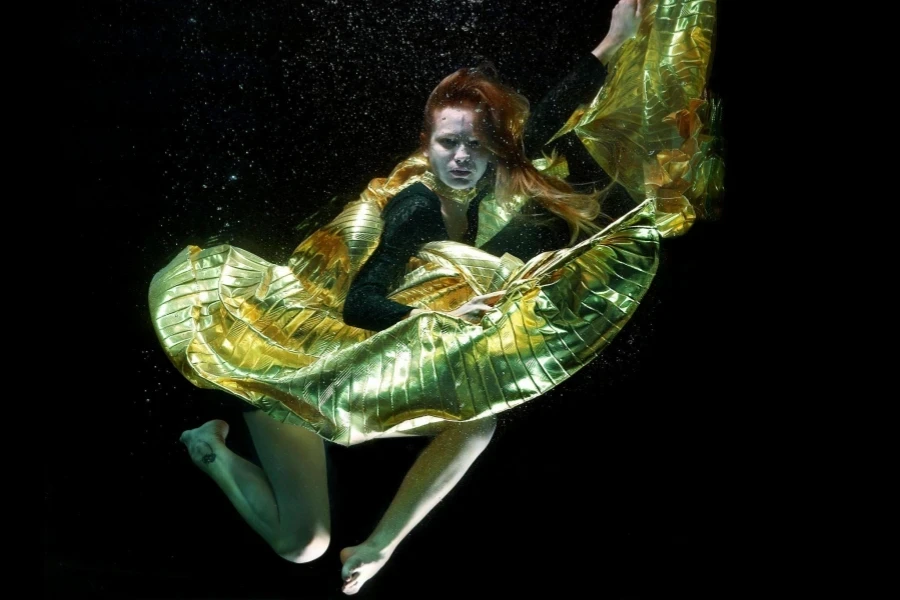 Underwater Photo of Woman Wearing Green and Black Dress