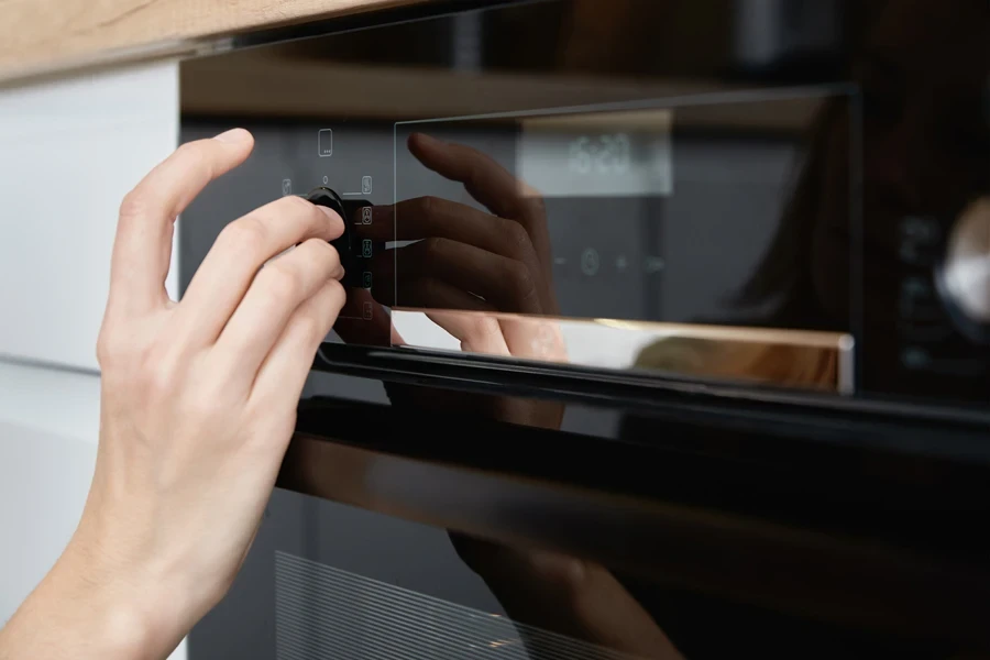 Woman choosing a program on an AI oven