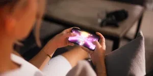 Une femme joue à un jeu de course mobile sur un smartphone