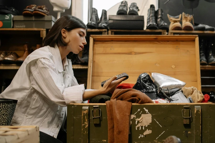 Woman reviewing goods in a consignment store