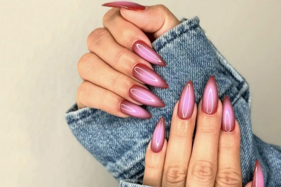 Woman wearing jean jacket with pink aura nails