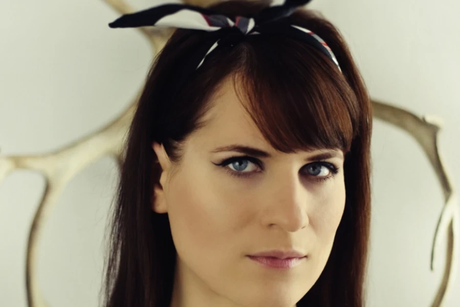 Woman with black hair wearing a knotted headband