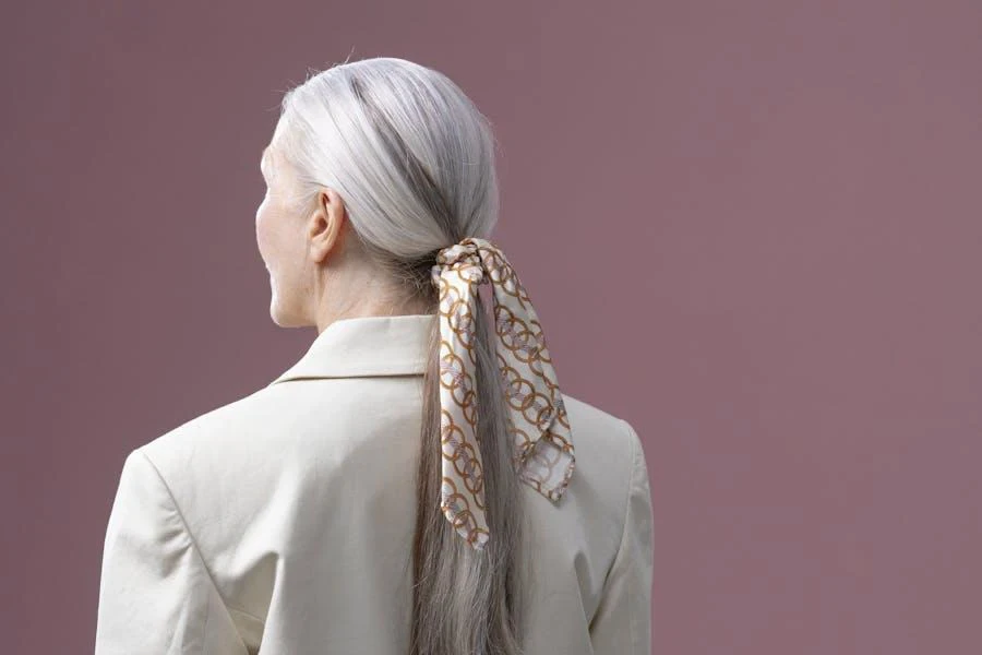 Woman with gray hair wearing a ponytail headscarf