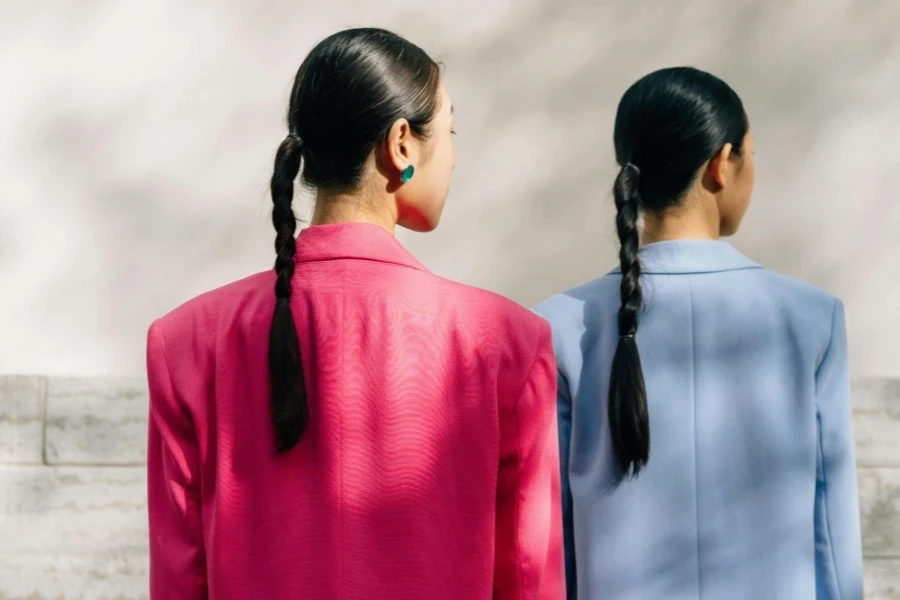 Women Wearing Blazers Near Concrete Wall