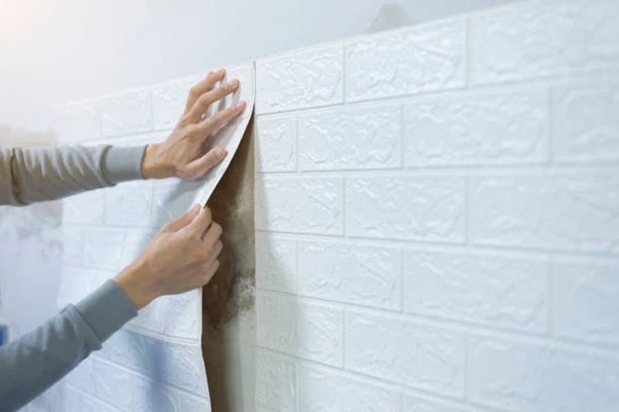 Worker hands sticking wallpaper on wall, Home decoration by yourself, Copy space.