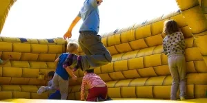 Kids playing in a bouncing castle during summer