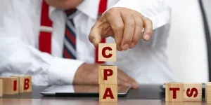 Man arranging CPA on word blocks