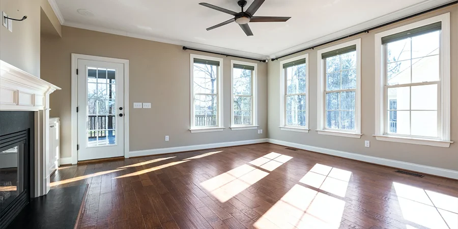 An empty living room with hardwood flooring