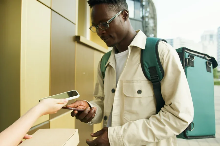 Man in cream-colored chore jacket with a backpack