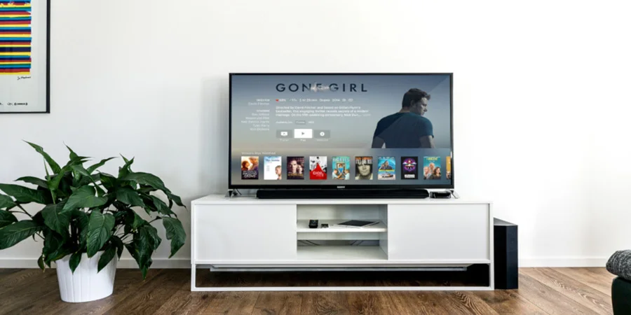 white tv stand with a tv on top